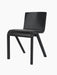 A three-quarter view of the Ready Dining Chair. It has a black painted oak frame and a seat upholstered in dark material.