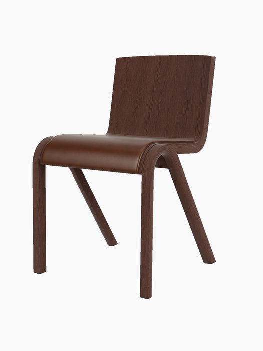 A three-quarter view of the Ready Dining Chair with an upholstered seat, red-stained oak frame and brown upholstery.