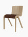 A three-quarter view of the Ready Dining Chair with a natural oak veneer frame and a seat upholstered in brown bouclé fabric.