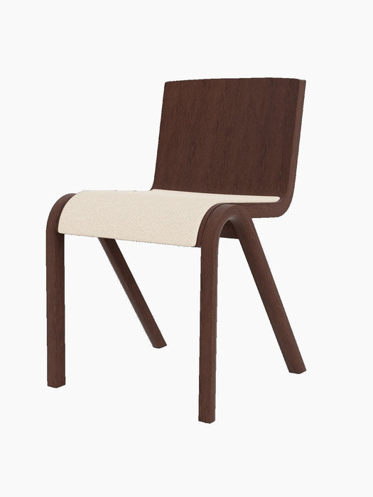 The Ready Dining Chair with its seat upholstered in cream Logan Jasmine fabric and its frame made of dark, red-stained oak.