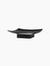 Angled view of the Releve Platter in black wood. The long, sculptural platter has curved, upturned edges and a solid base.