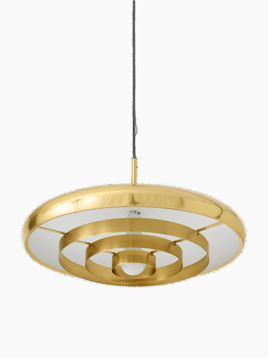 A low-angle shot of the polished brass Resonant Pendant lamp, showing its four concentric shades against a black background.