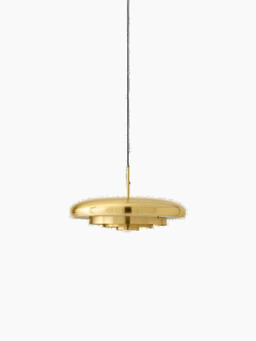 Front view of the Resonant Pendant in polished brass, featuring four concentric shades hanging against a black background.