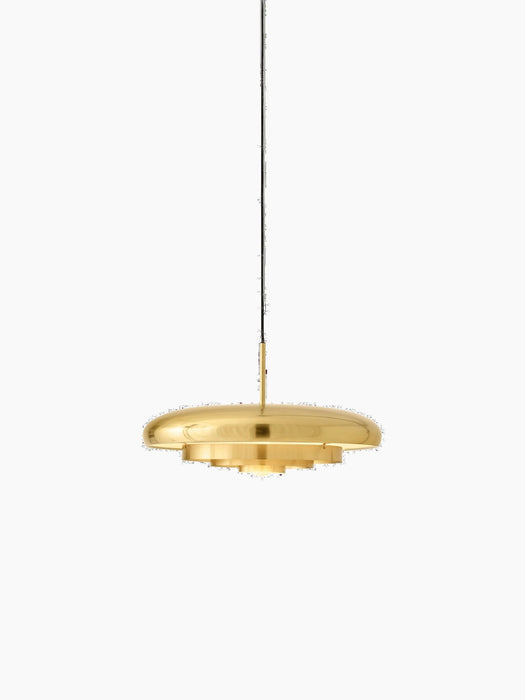 A front-on view of the Resonant Pendant in polished brass. The lamp is on, illuminating its four concentric shades.