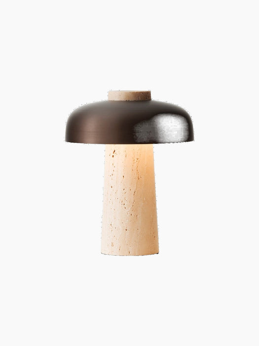 The Reverse Table Lamp, Portable, switched on, with a conical travertine base and a curved, bronzed aluminium shade.