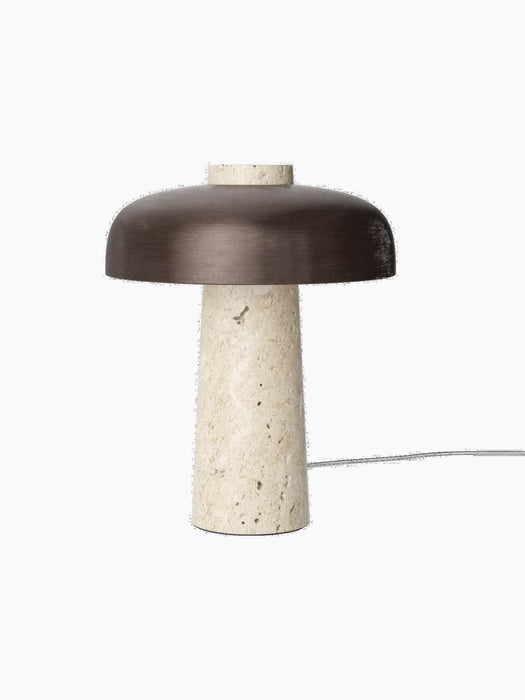 Front view of the Reverse Table Lamp, with a conical base of light, textured travertine and a bronzed aluminium shade.