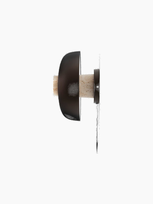 Side profile of the Reverse Wall Lamp, unlit, with a textured travertine base and smooth bronzed aluminium shade.