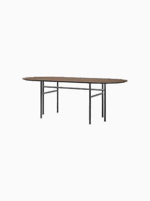 The Snaregade Oval Table with a dark stained oak top and a minimalist black steel base, shown from a front angle.