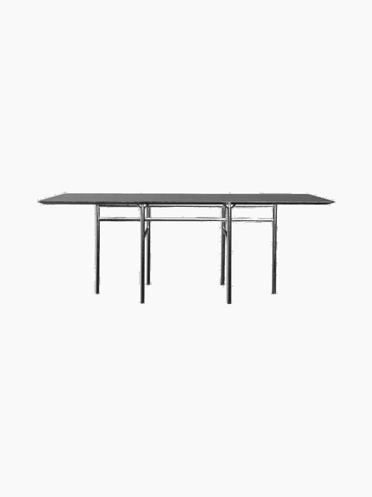 A full side view of the Snaregade Dining Table, Rectangular, in black oak veneer with a black powder-coated steel base.