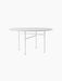 Studio shot of the round Snaregade Dining Table. It has a light grey mushroom linoleum top and a slim, white geometric base.