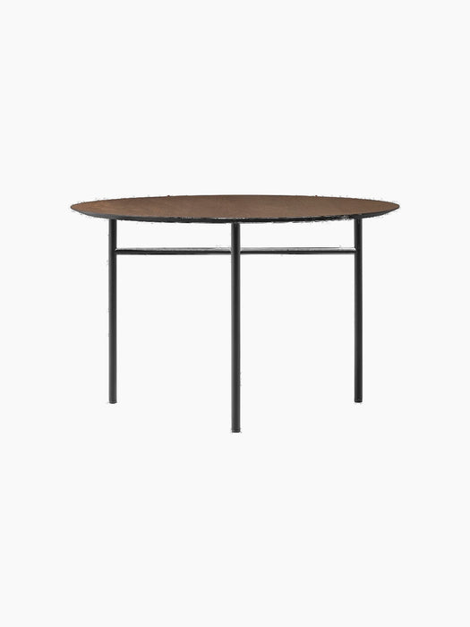 Front view of the Snaregade Dining Table, Round, featuring a dark stained oak top and a minimalist black steel base.