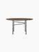 Front view of the Snaregade Dining Table, Round, with a dark stained oak top and a complex, geometric black steel base.