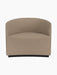 The Tearoom Lounge Chair, upholstered in light brown, textured Logan Flint fabric against a black background.