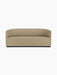 A front-on studio shot of the Tearoom Sofa upholstered in light beige Audo Bouclé 02, featuring its curved back and arms.