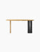Front view of The Eclipse Desk in natural oiled oak. Asymmetrical top, flat oak leg, and a black cylindrical column leg.