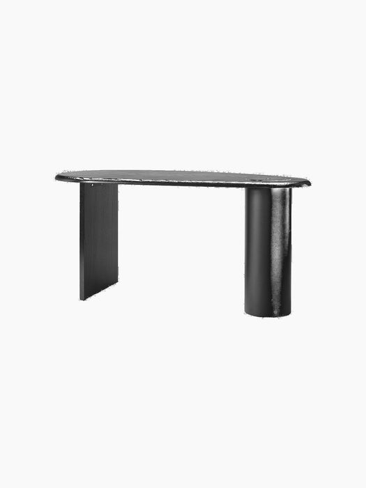 The Eclipse Desk in black lacquered oak from an angle. Asymmetrical design with a curved top, a flat and a cylindrical leg.