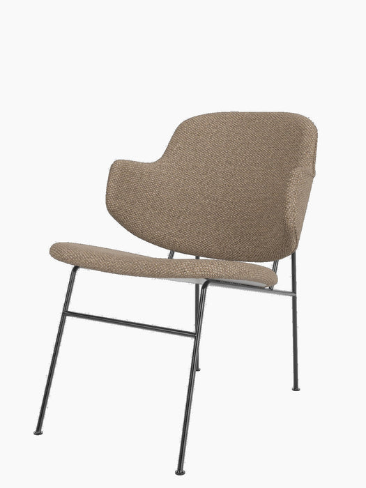 A three-quarter view of The Penguin Lounge Chair, fully upholstered in textured Logan Flint fabric with a slim dark frame.