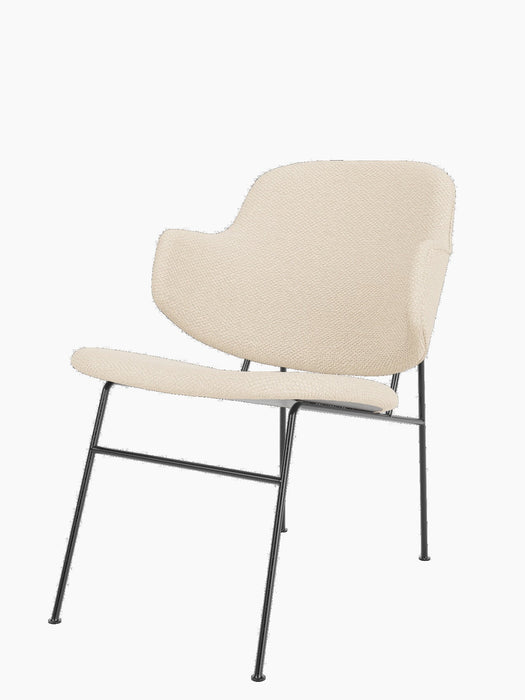 A three-quarter view of The Penguin Lounge Chair, upholstered in textured cream Logan Jasmine fabric on a black steel frame.