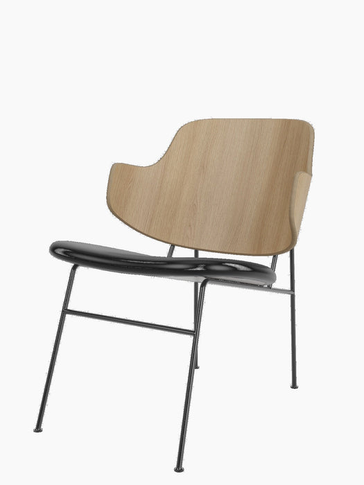 The Penguin Lounge Chair with a natural oak veneer backrest, a black upholstered seat, and black powder-coated steel frame.
