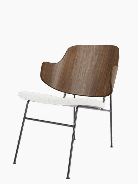 The Penguin Lounge Chair with a curved walnut veneer backrest, light grey upholstered seat, and a slender black steel frame.