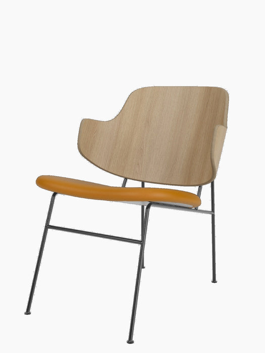 The Penguin Lounge Chair with a curved natural oak back, a tan leather seat, and a slim, dark powder-coated steel frame.