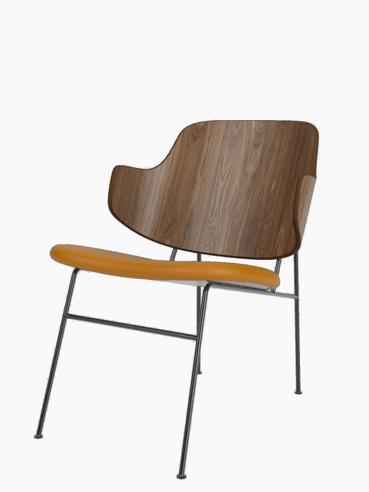 The Penguin Lounge Chair, featuring a curved walnut veneer backrest and a tan upholstered seat on a thin black metal frame.