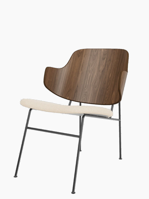 The Penguin Lounge Chair in Walnut with a Logan Jasmine upholstered seat and black steel frame, viewed from the side.