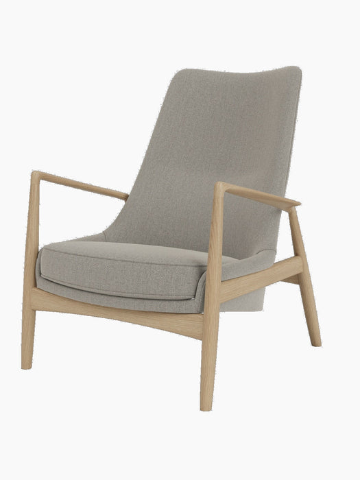 A front-side view of The Seal Lounge Chair, High Back, featuring a natural oak frame and light grey Re-Wool upholstery.