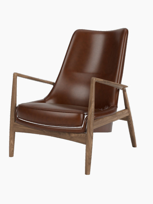 The Seal Lounge Chair, High Back, featuring a sculptural walnut frame and a floating high-backed seat in rich brown leather.