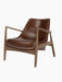 A three-quarter view of The Seal Lounge Chair, Low Back, featuring a dark walnut frame and smooth, brown leather seating.