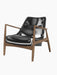 A three-quarter view of The Seal Lounge Chair, Low Back, with black leather seat and backrest and a walnut frame.