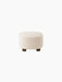 Back view of The Tired Man Ottoman in plush, off-white textile. It has a rounded shape and sits on four short, dark oak legs.