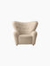 Front view of The Tired Man Lounge Chair in a cream textured fabric, with a high, curved back and button tufting.