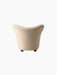 Back view of The Tired Man Lounge Chair in a textured, off-white fabric, showing its curved shape and dark wooden legs.