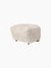 The Tired Man Ottoman in soft, off-white Moonlight sheepskin. The plush footstool features oak legs with brass castors.