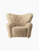 Front view of The Tired Man Lounge Chair in plush honey sheepskin, with a wide winged back and thick rounded arms.