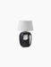 A studio shot of the black Torso Portable Table Lamp, featuring a glossy, rounded ceramic base and a white linen lampshade.