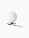 Rear view of the TR Bulb Ceiling/Wall Lamp, spherical opal glass shade on a circular brushed brass base with its black cord.