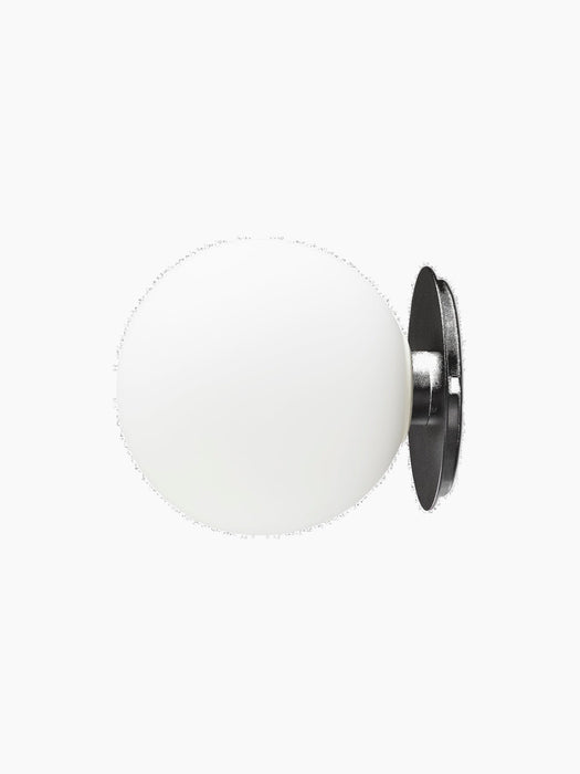 A side view of the TR Bulb Ceiling/Wall Lamp, showing its oval white opal glass shade attached to a black circular base.