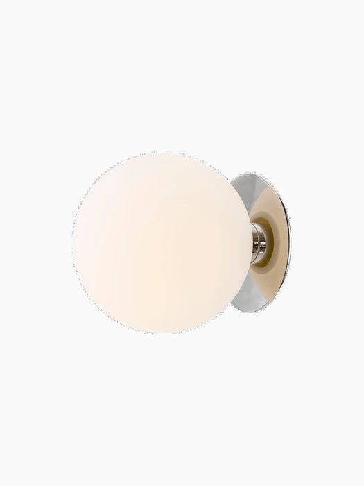 Angled view of TR Bulb, Ceiling/Wall Lamp. A large, glowing opal glass sphere is mounted on a polished steel circular base.