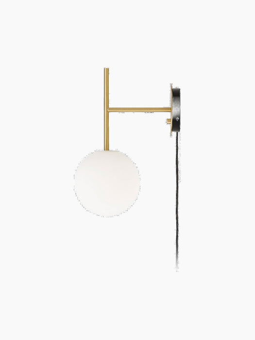 A side-on view of the TR Bulb, Suspended Wall Lamp, with a brushed brass T-shaped frame and illuminated round opal glass bulb