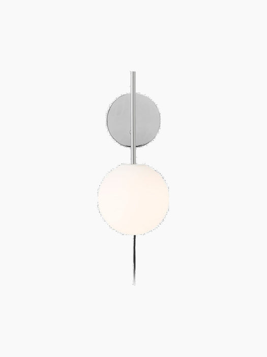 TR Bulb Suspended Wall Lamp in polished steel. A vertical rod connects the circular wall plate to the glowing opal bulb.