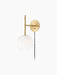 Angled view of the TR Bulb, Suspended Wall Lamp in brushed brass, featuring a glowing spherical white opal glass bulb.