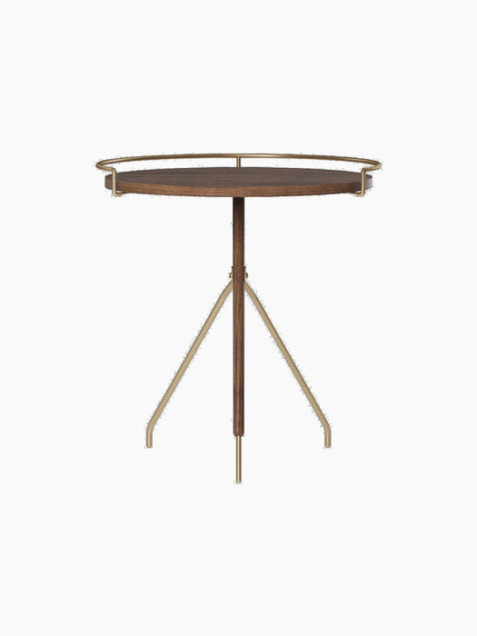 Front view of the Umanoff Side Table, featuring a round walnut tabletop with a raised brushed brass rail on a tripod base.