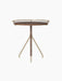 Front view of the Umanoff Side Table, featuring a round walnut tabletop with a raised brushed brass rail on a tripod base.