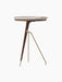 The Umanoff Side Table in dark walnut and brushed brass, shown from an angle. Tall version with a tripod base and round top.