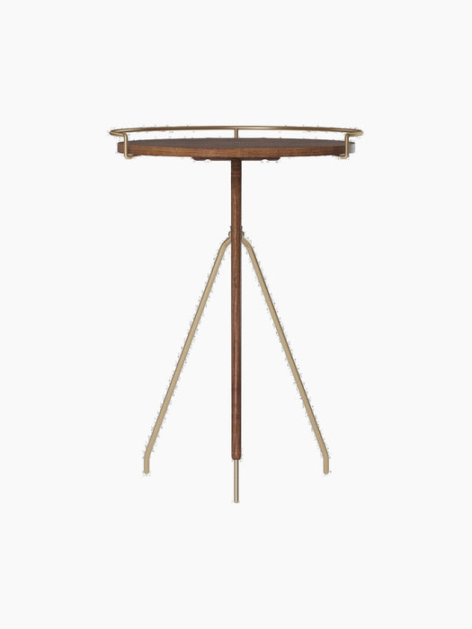 The tall Umanoff Side Table, shown from the front, featuring a solid walnut top with a brushed brass rail and a tripod base.