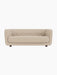 Front view of the Vilhelm Sofa, upholstered in light beige Sahco Zero 1 fabric with button details and dark smoked oak legs.