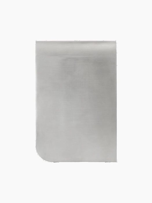 Rear view of the aluminium Volume Side Table, showcasing its unique silhouette with a curved corner and brushed metal finish.
