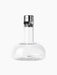 A clear glass Wine Breather carafe with a wide, rounded base, a slim neck, and a stainless steel and black aerating stopper.